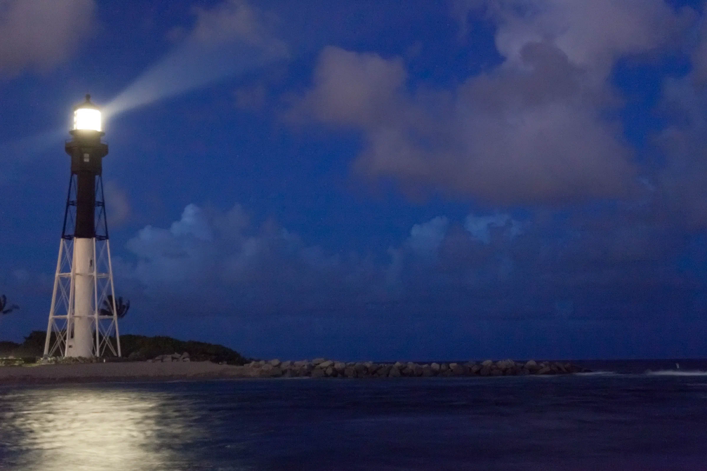 The Hillsboro Inlet Lighthouse shining at dusk