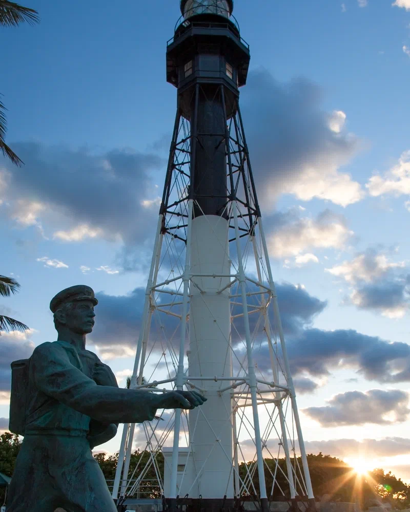 The Barefoot Mailman statue in front of the lighthouse
